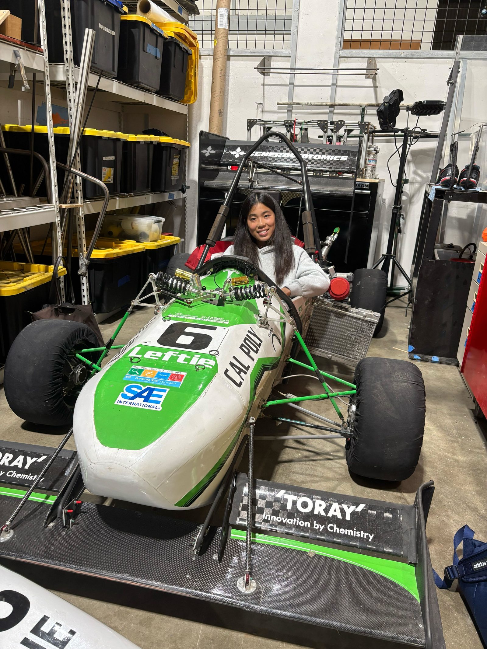 Kristin Der with the Cal Poly Racing Formula SAE vehicle